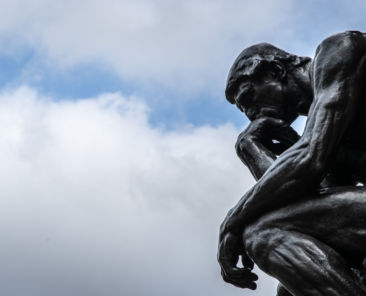 19 February 2020, North Rhine-Westphalia, Bielefeld: The sculpture "The Thinker" ("Le Penseur") by the sculptor Auguste Rodin can be seen against a cloudy sky. Photo: Friso Gentsch/dpa